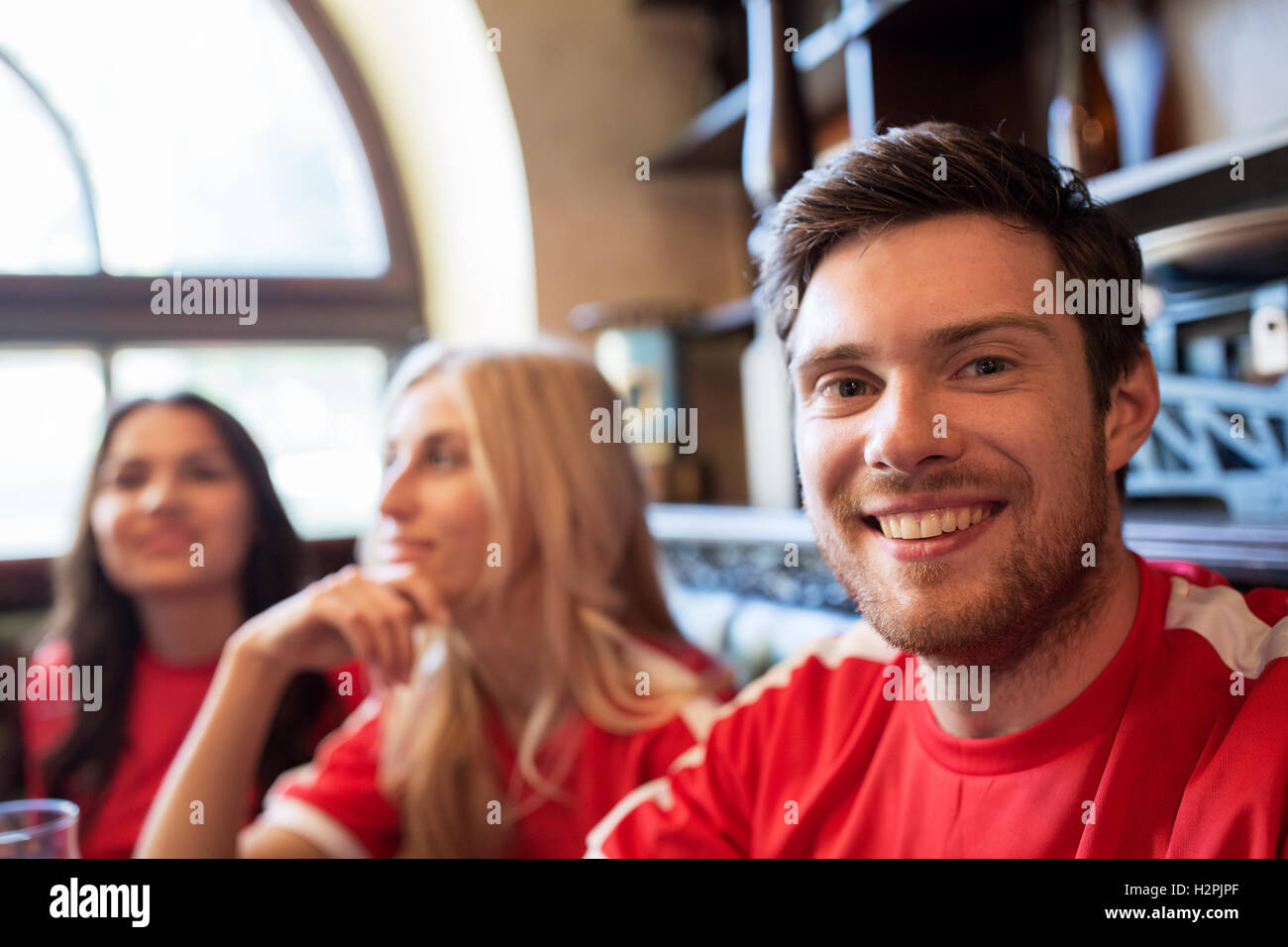 fans or friends watching football at sport bar Stock Photo - Alamy