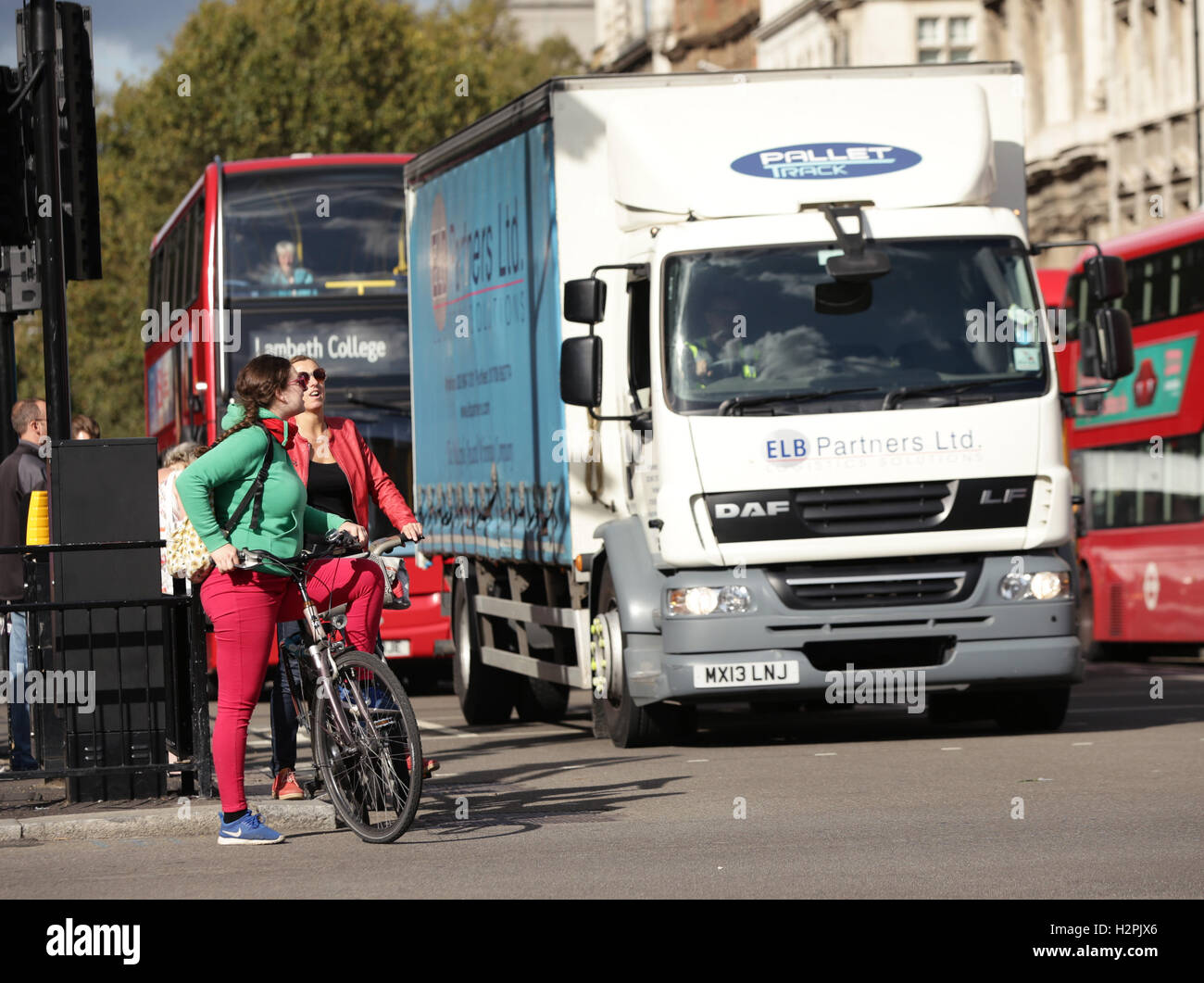Cyclists wait for the green traffic lights at Parliament Square in Westminster, London. Thousands of lorries could be banned from London under plans to make the capital's roads safer for cyclists. Stock Photo