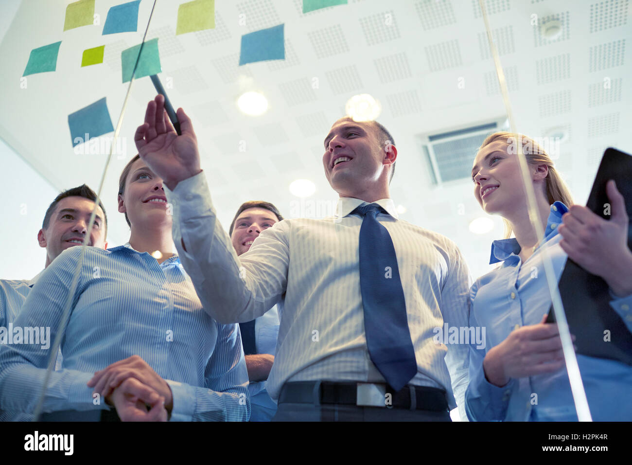 smiling business people with marker and stickers Stock Photo - Alamy