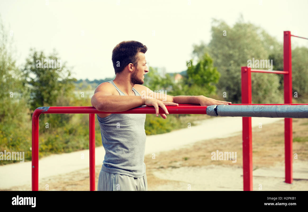 young man exercising on parallel bars outdoors Stock Photo - Alamy