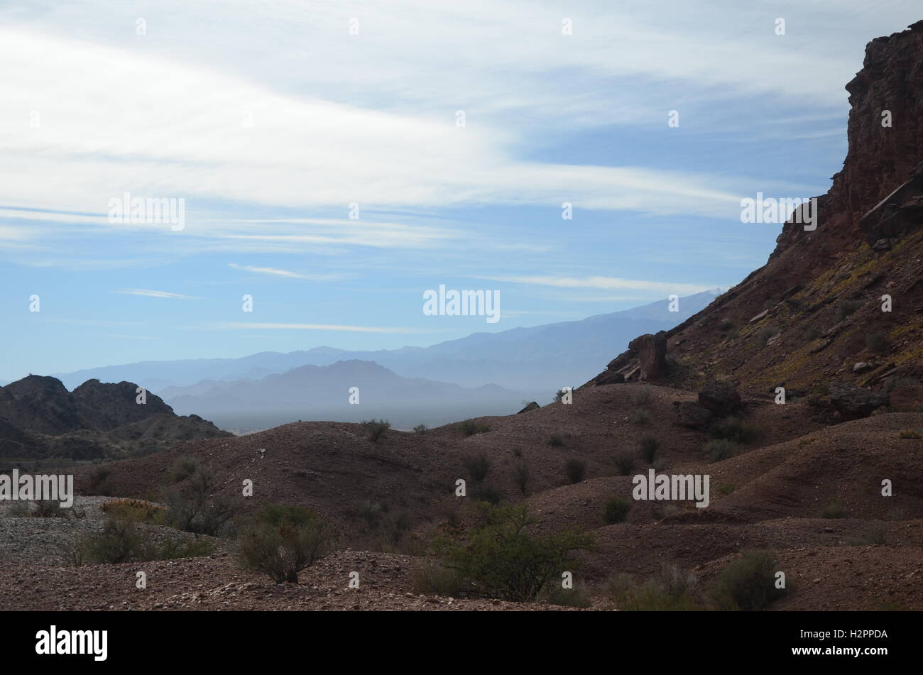 Small hills and hasy blue mountains Stock Photo