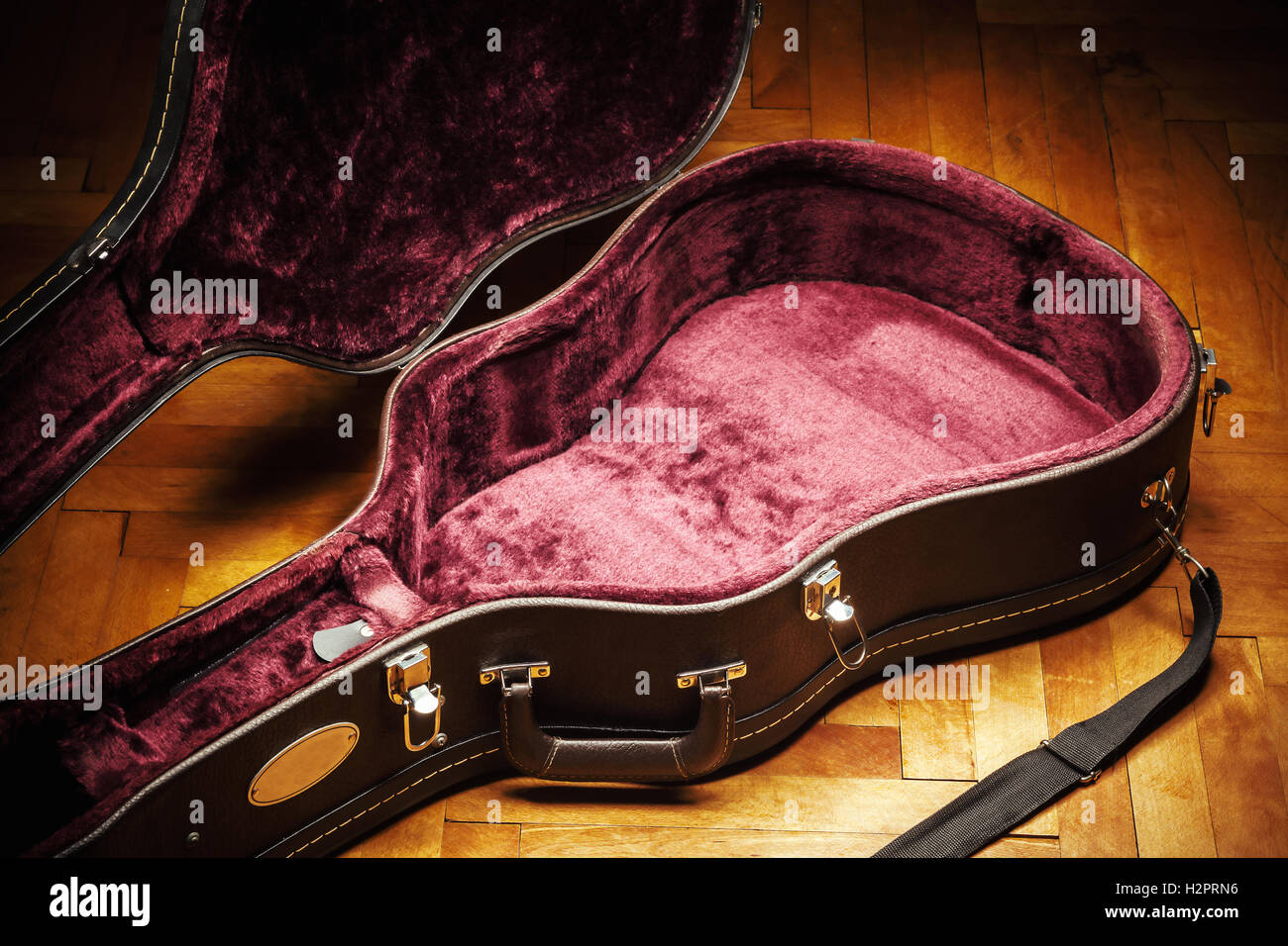 Old opened retro acoustic guitar suitcase on parquet. Details of