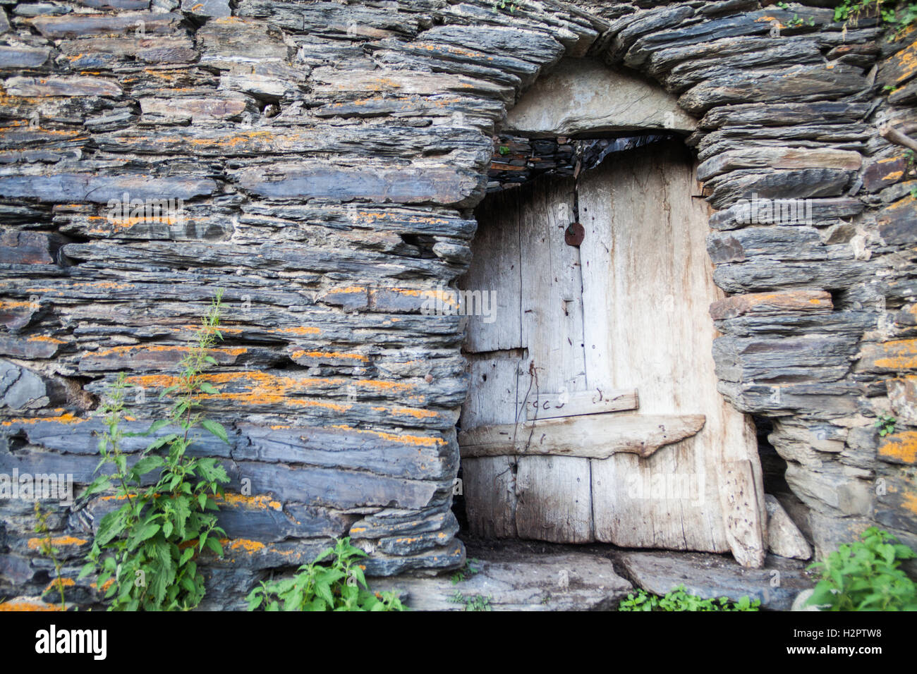 Color image of an old door on a stone wall Stock Photo - Alamy