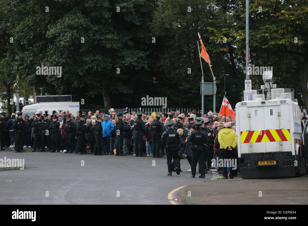 Police Service of Northern Ireland (PSNI) officers monitor a group of ...