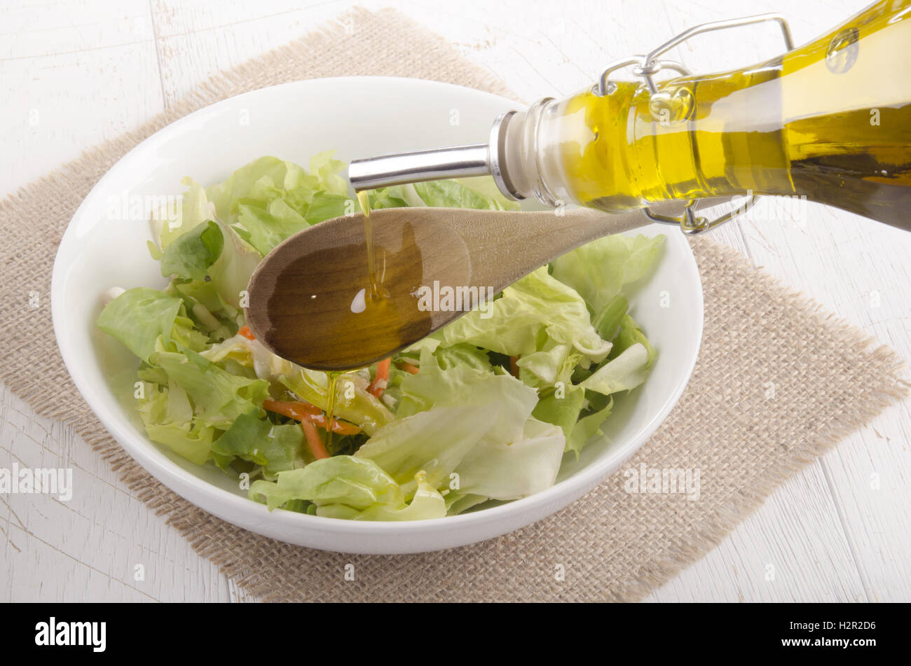 olive oil is poured into a salad bowl Stock Photo Alamy