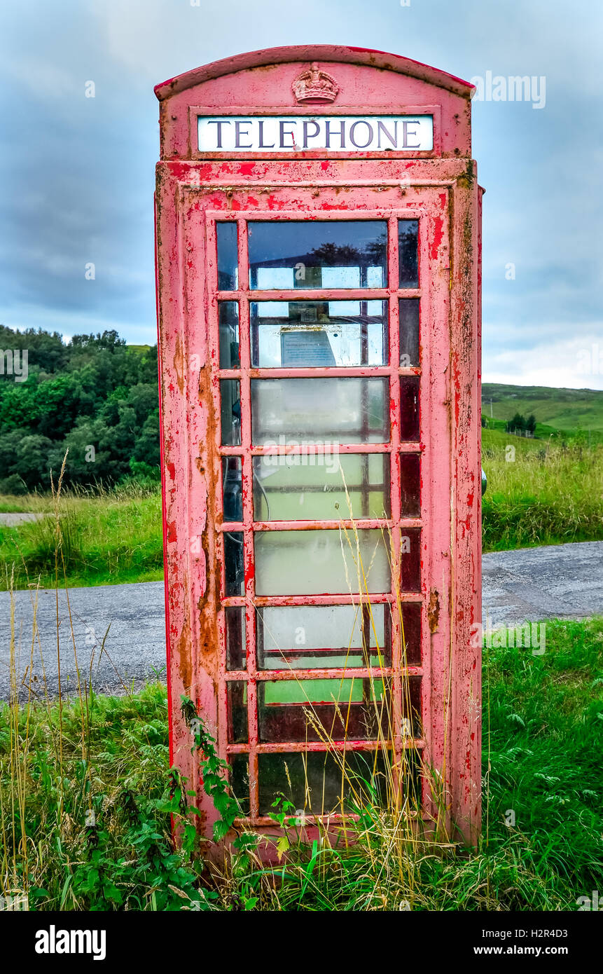 Detail of old red English phone booth in countryside Stock Photo
