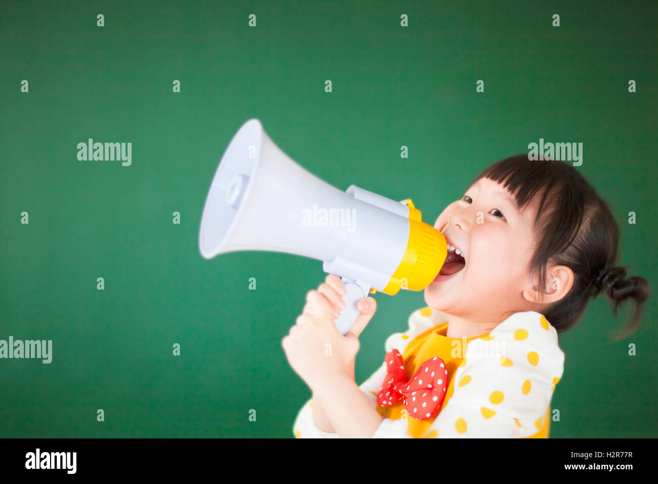 cute child using a megaphone in a classroom Stock Photo - Alamy
