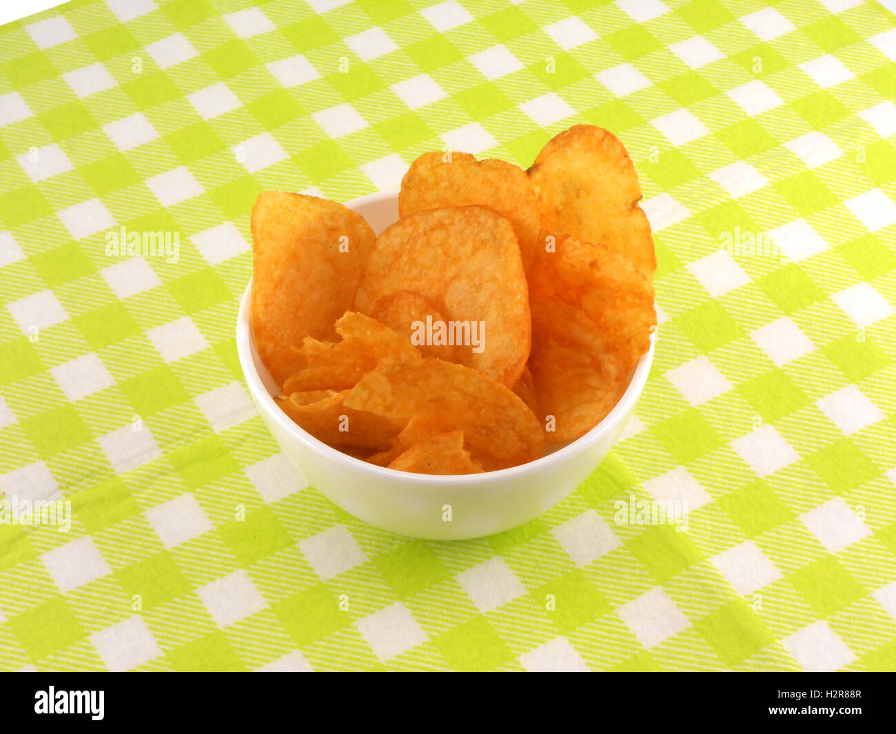 Potato chips falling in the white plate Stock Photo Alamy