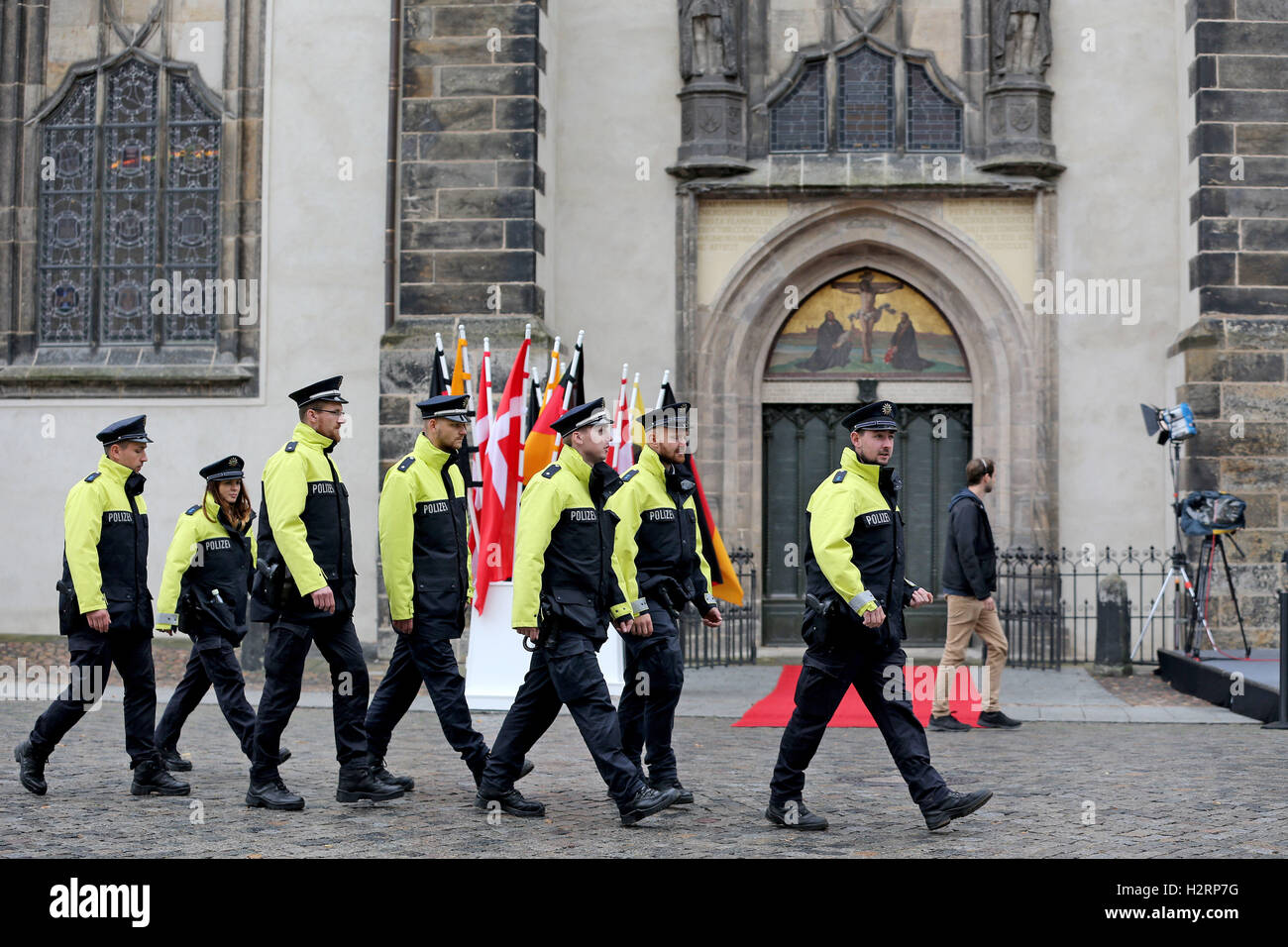 Wittenberg, Germany. 2nd Oct, 2016. Police officers walk in front the