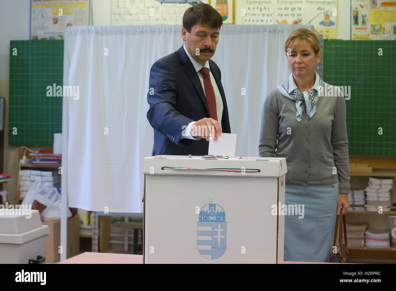 (161002) -- BUDAPEST, Oct. 2, 2016 (Xinhua) -- Hungarian President Janos Ader casts vote during a referendum on EU migrant quotas at a polling station in Budapest, Hungary, on Oct. 2, 2016. Polling stations across Hungary opened at 6 a.m. local time (0400 GMT) on Sunday for a government-sponsored anti-migrant referendum, initiated to counter an EU plan to distribute asylum seekers among its member states. (Xinhua/Attila Volgyi) (zy) Stock Photo
