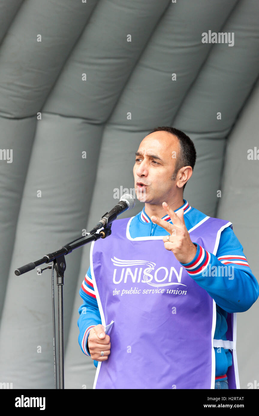 Birmingham, West Midlands, UK. 2nd October 2016. Regional secretary of Unison, Ravi Subramanian, gives a speech at the rally in Eastside Green, Birmingham. Thousands take part in a national demonstration - ‘Protest The Tory Conference’ - to protest against austerity, economic and social malaise in the UK. The protest is organised by The People’s Assembly and scheduled to coincide with the annual Conservative Party Conference which is being held in Birmingham, West Midlands, UK. between 2nd – 5th October 2016. Credit:  Graham M. Lawrence/Alamy Live News. Stock Photo