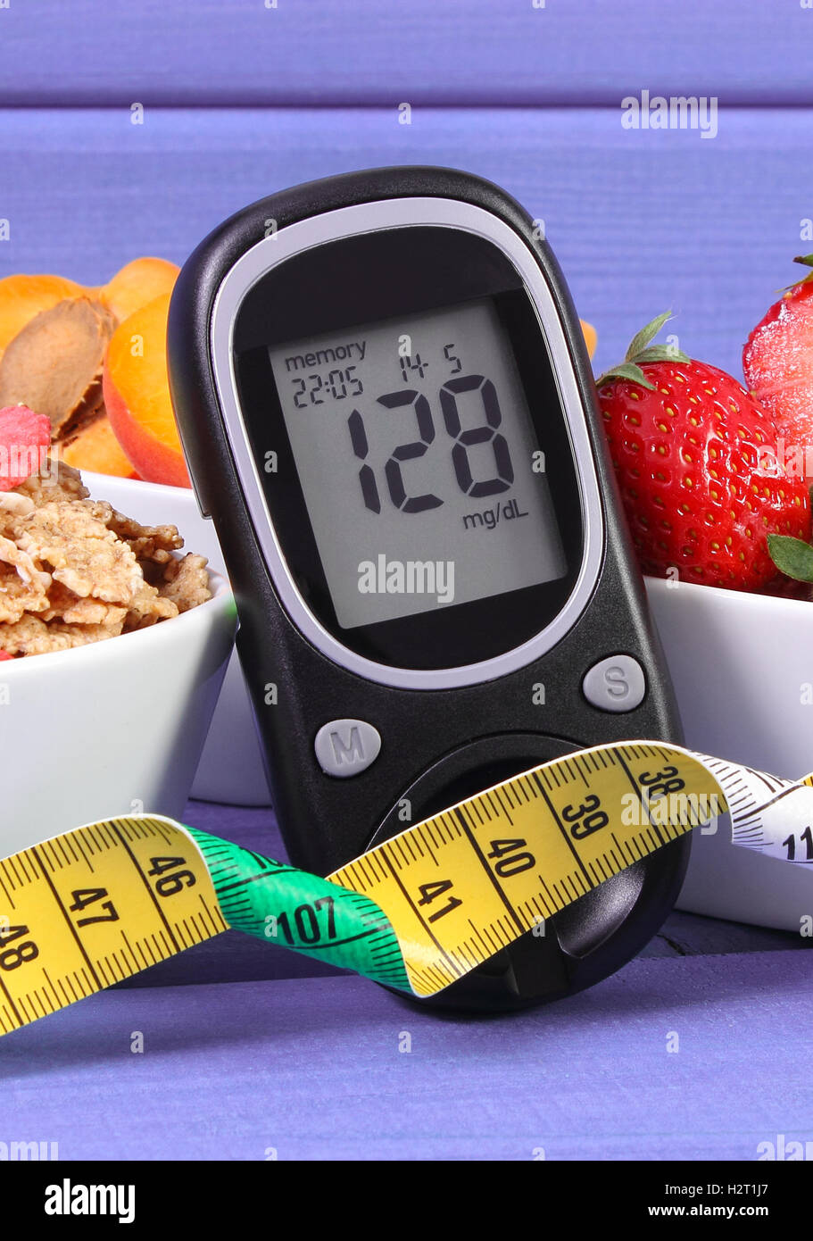Glucose meter with result of measurement sugar level, healthy food and