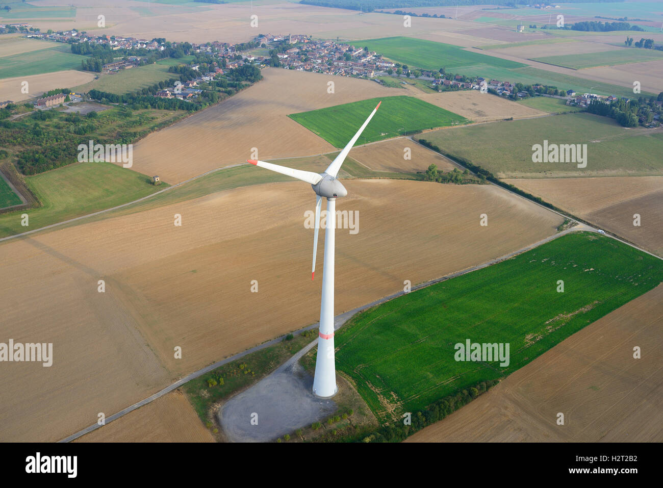 AERIAL VIEW. 198-meter-high Enercon E-126 wind turbine. Estinnes, Province of Hainaut, Wallonia, Belgium. Stock Photo