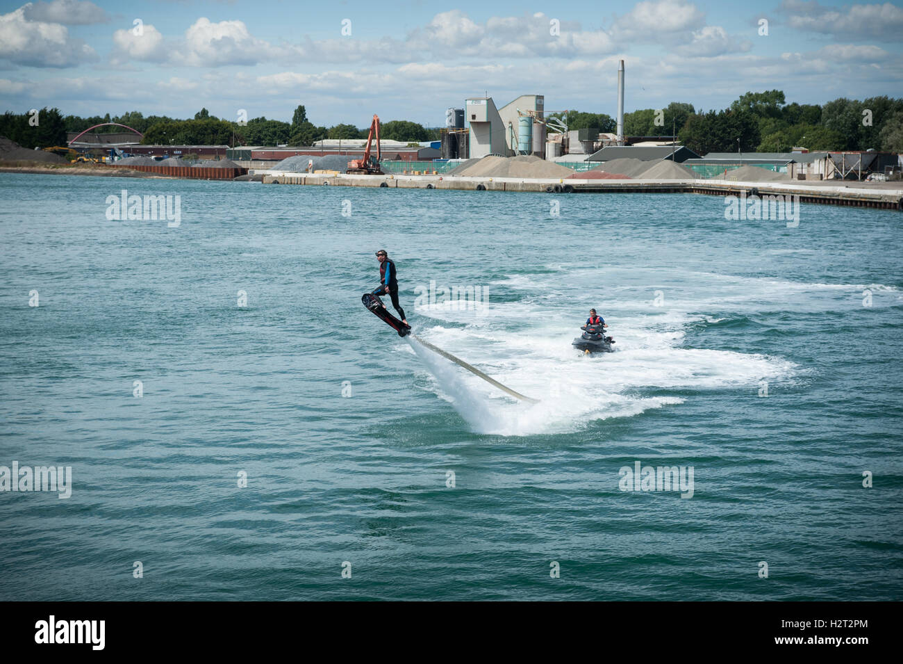 A flyboarder is thrust into the air by a jet of high pressure water