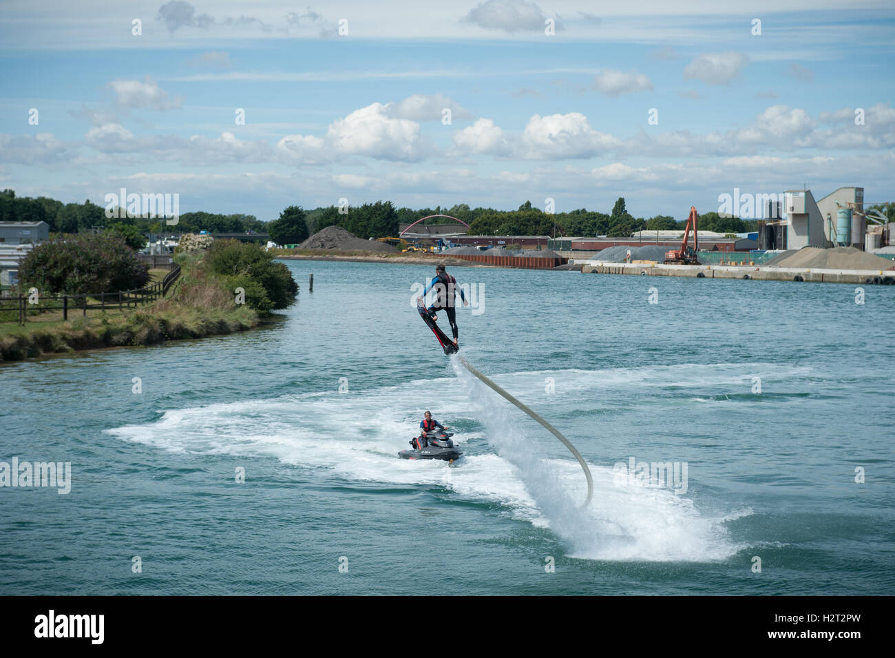 A flyboarder is thrust into the air by a jet of high pressure water