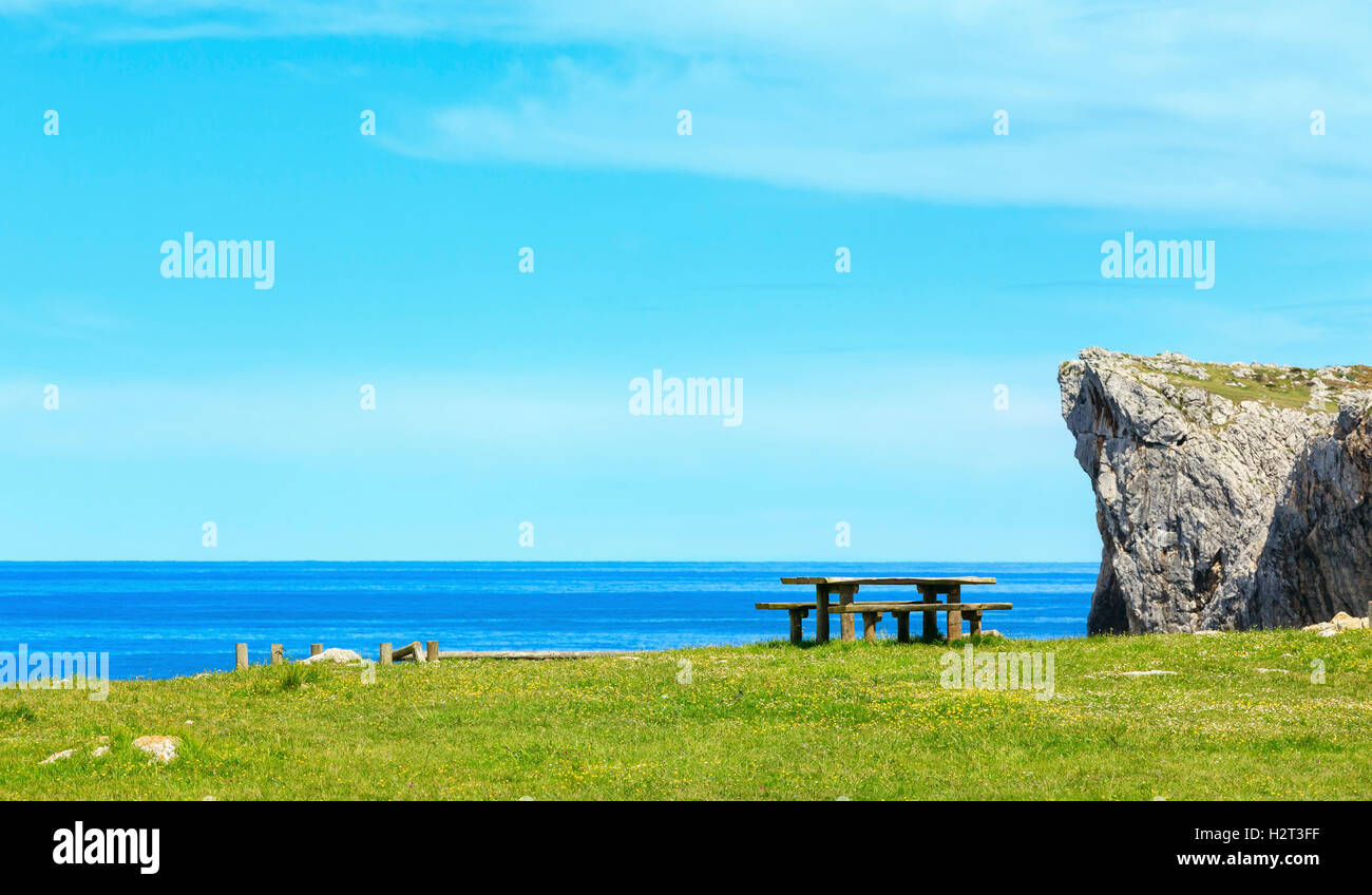 Place of rest (table with benches) on summer blossoming sea coast near ...