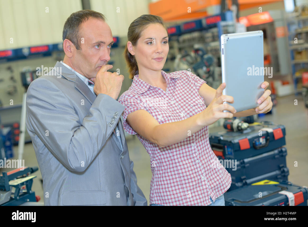 Man and woman in hardware store holding tablet Stock Photo