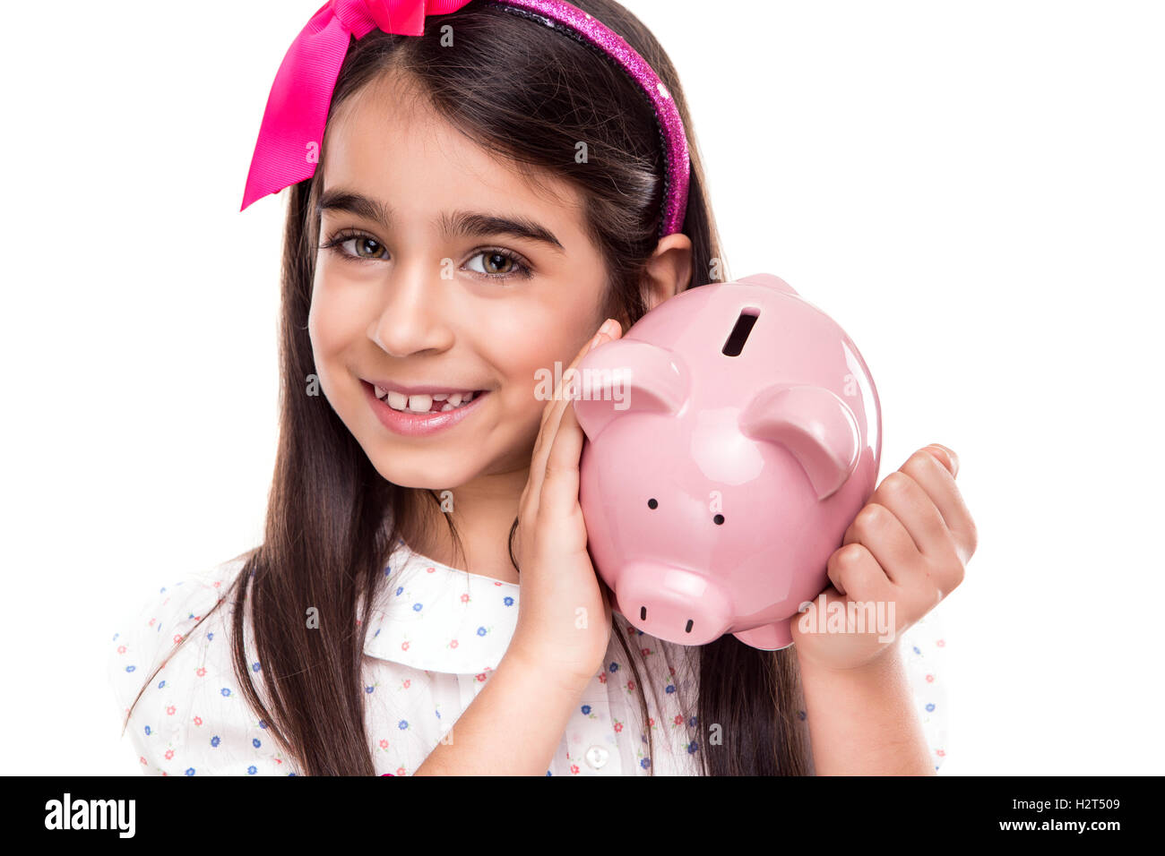 Girl holding a piggy bank Stock Photo - Alamy