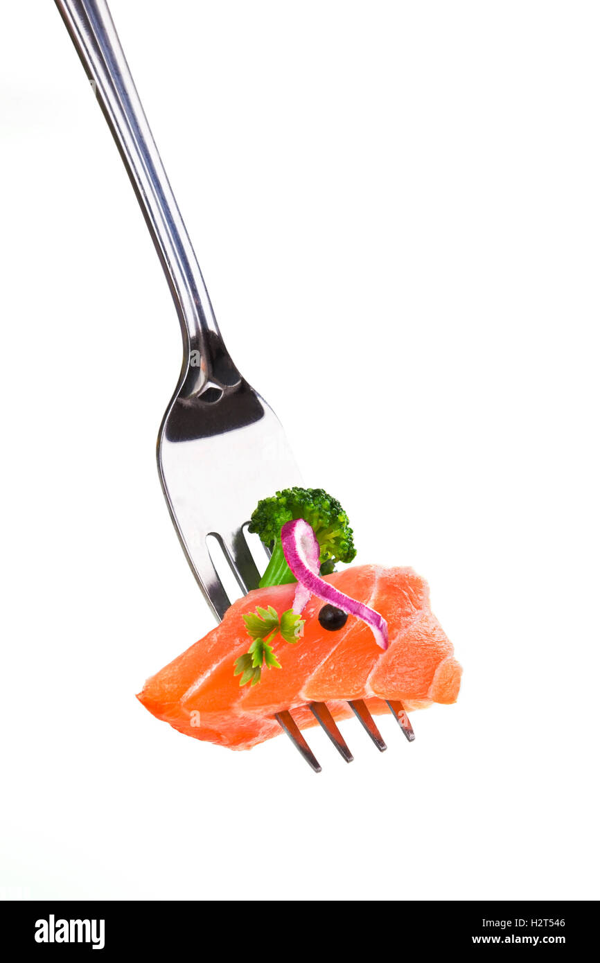 Delicious salmon piece on fork against white background. Stock Photo