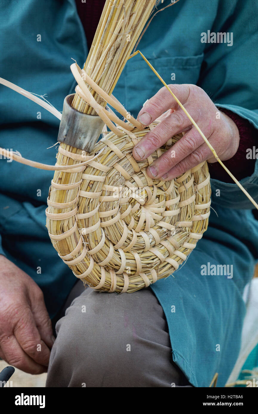 Man / beekeeper making a traditional bee skep at at Dalyseford autumn show. England Stock Photo