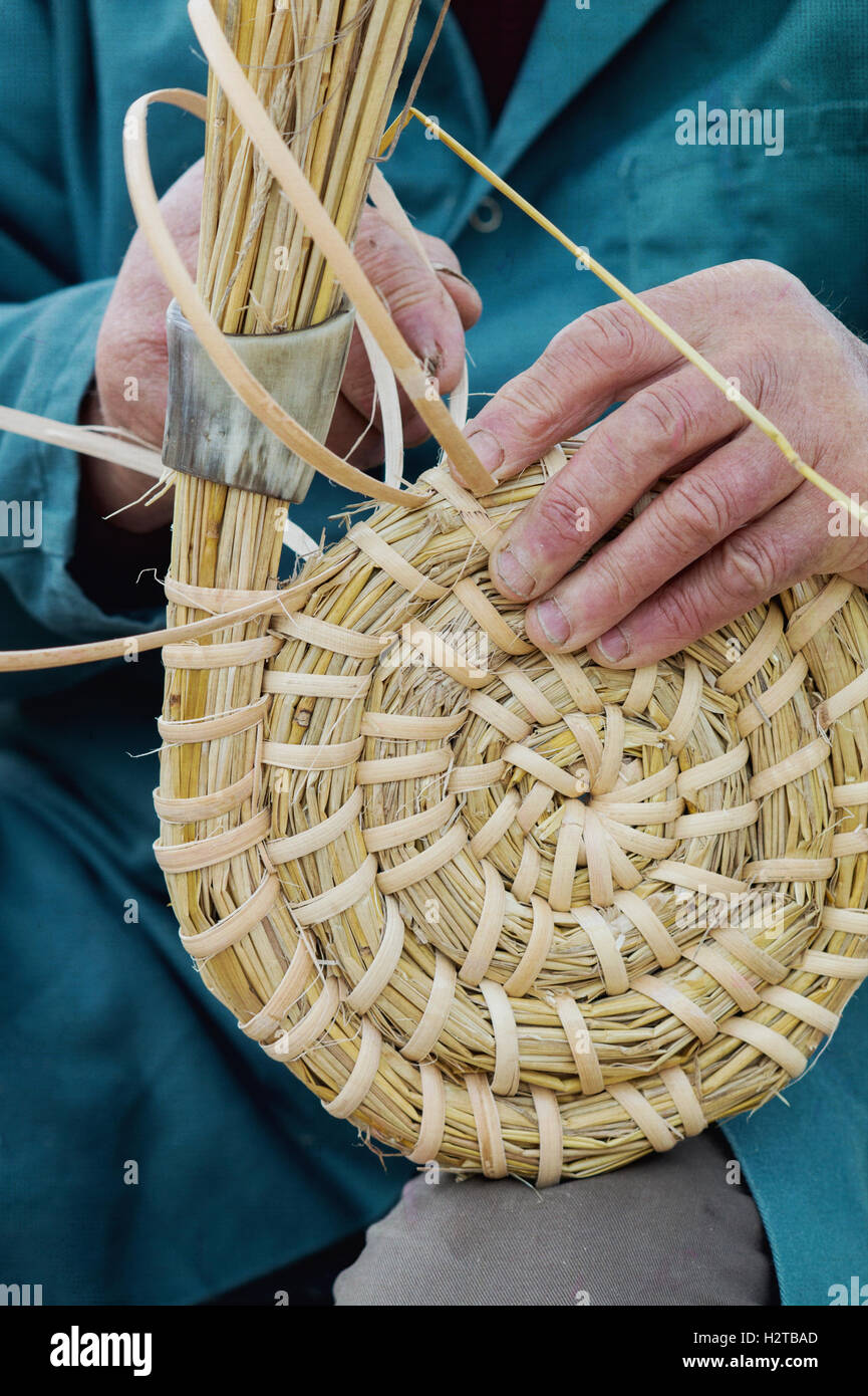 Man / beekeeper making a traditional bee skep at at Dalyseford autumn show. England Stock Photo
