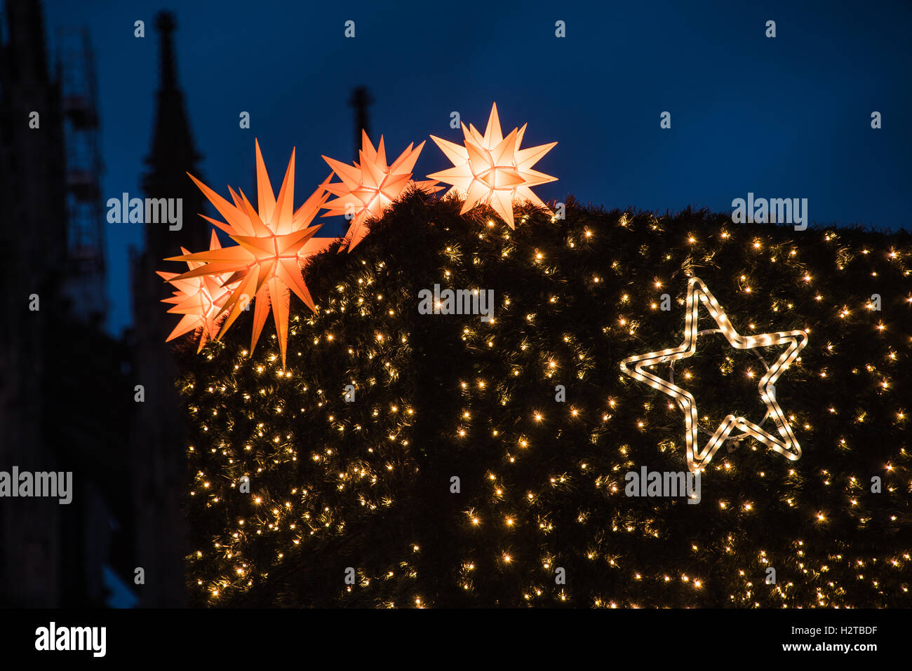 christmas lights and stars on a wall in the night Stock Photo