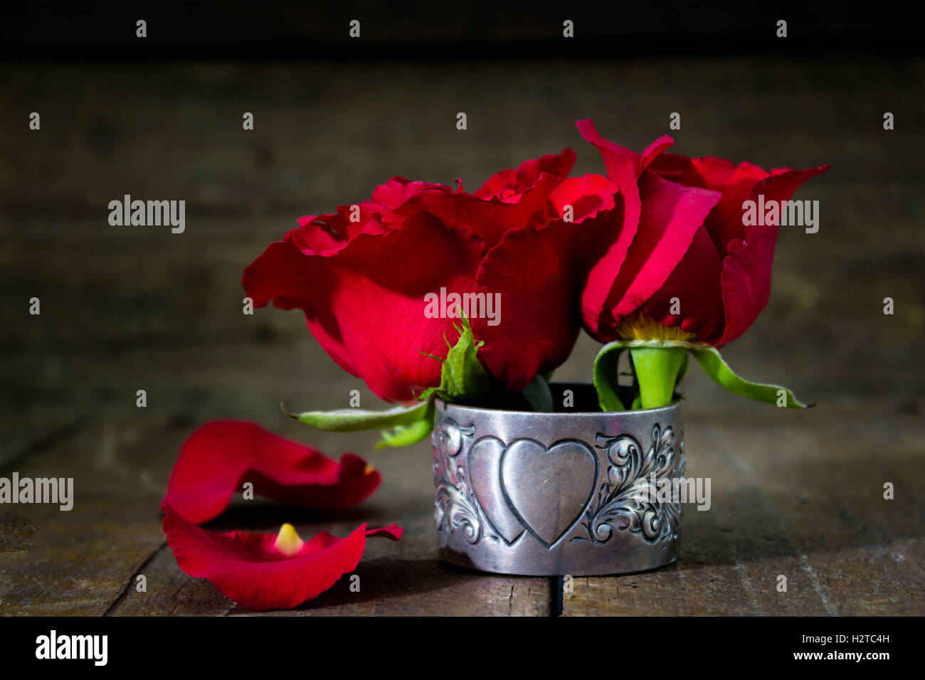 Romantic background with red short cut roses on rustic wood table Stock ...
