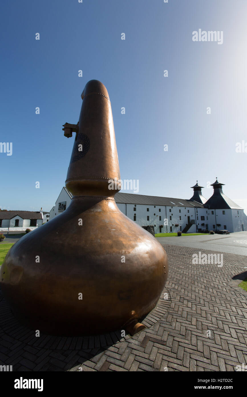 Isle of Islay, Scotland. Picturesque view of a whisky pot still, with the Ardbeg whisky distillery in the background. Stock Photo