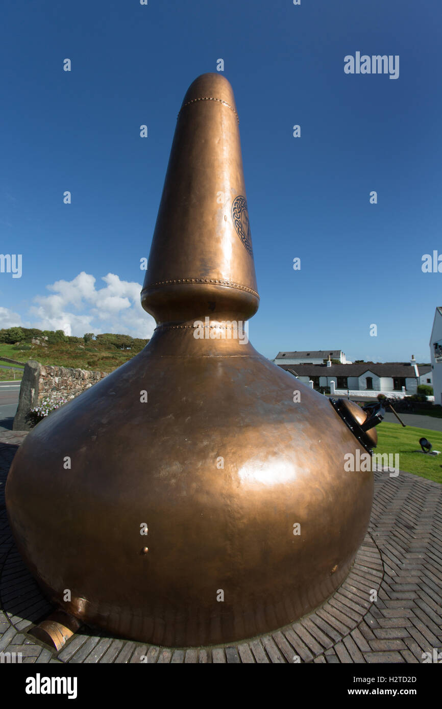Isle of Islay, Scotland. Picturesque view of a whisky pot still, with the Ardbeg whisky distillery in the background. Stock Photo