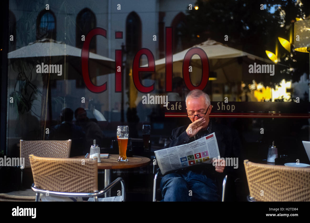 Man yawning outside a cafe Durlach Karlsruhe Baden-Württemberg Germany Stock Photo