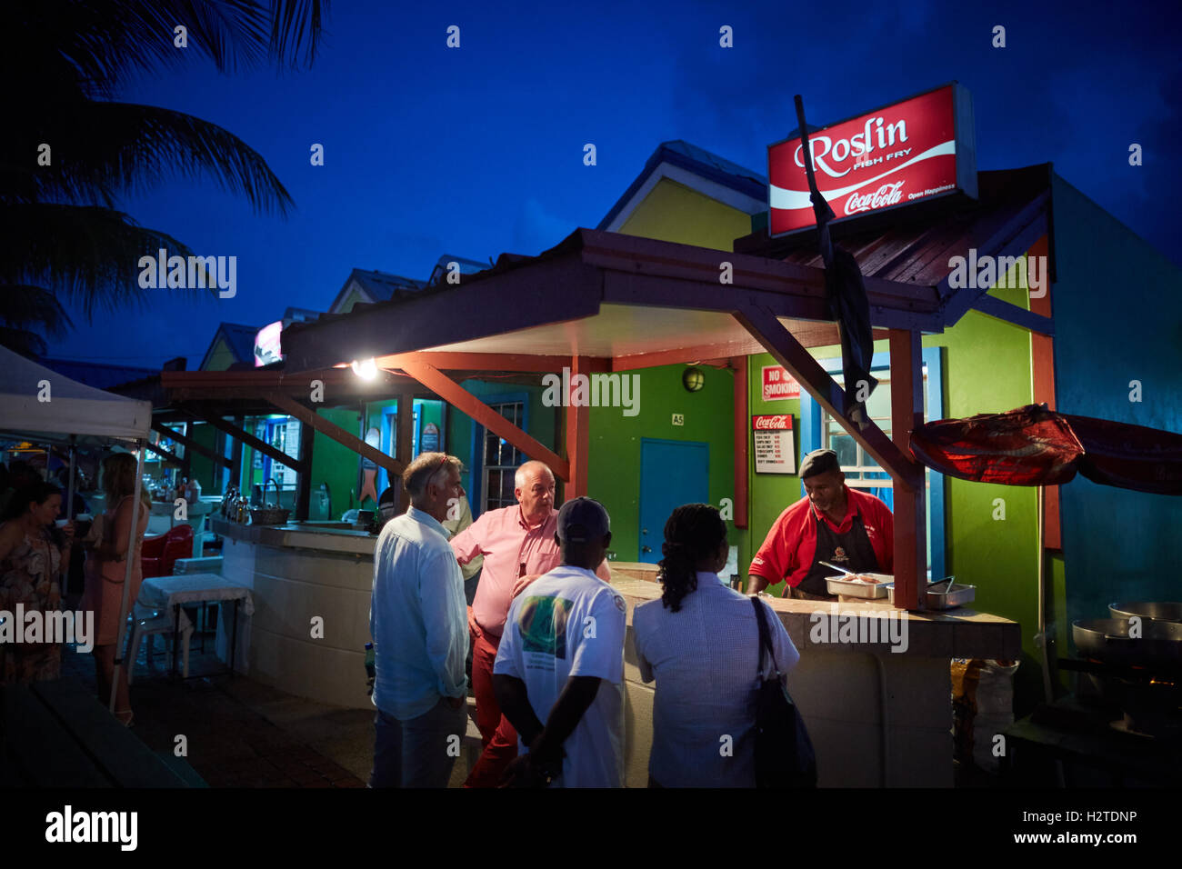 Barbados Oistins Roslin fish grilling eating food   coastal town parish Christ Church fishing village tourists hang out Friday n Stock Photo