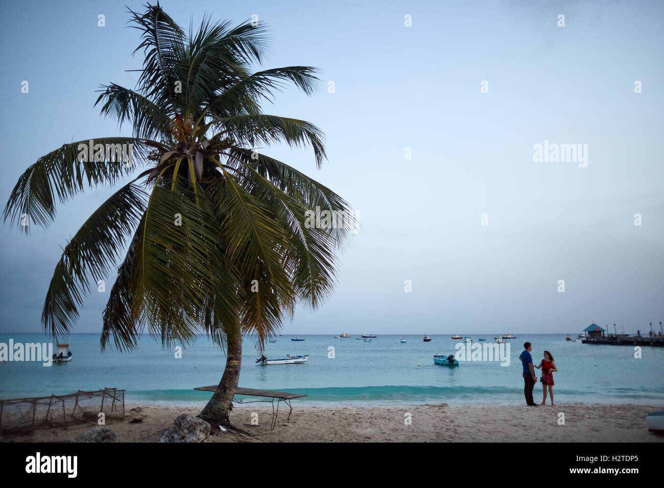 Barbados Oistins tourist beach lovers   coastal town parish Christ Church fishing village tourists hang out Friday night couple Stock Photo
