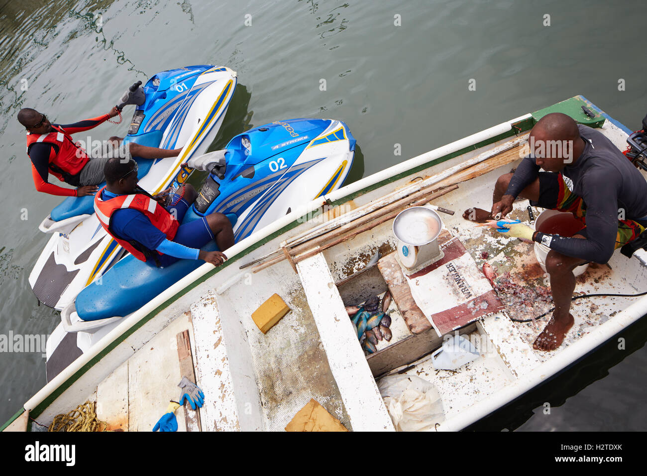 Barbados fisherman boat fishing police   scrapping local business trader man rowing boat worker workman fish caught Poor rundown Stock Photo