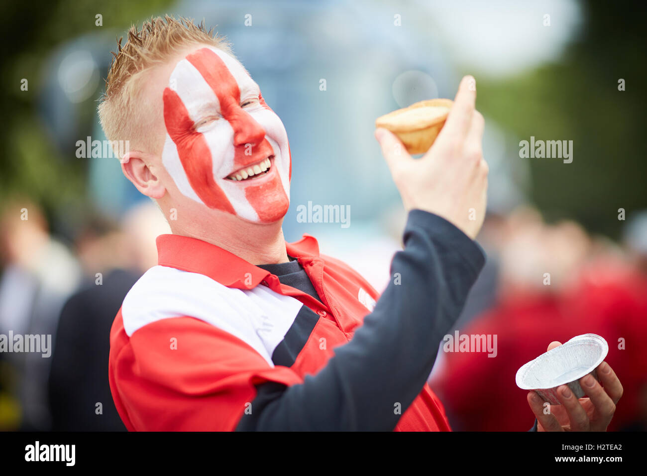 Football fan eating pies Hollands   Accrington Stanly FC fans match game eating pies happy laughing Young kids children youngste Stock Photo