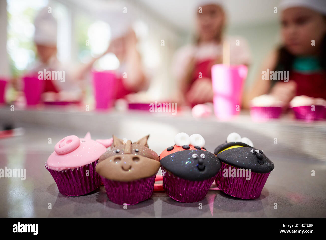 cup cakes animal faces farm   Children baking making fun cooking Young kids children youngsters child toddlers adolescents small Stock Photo