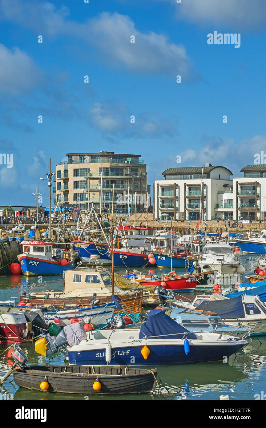 West Bay in Dorset is a small working harbour seen here with a mix of ...