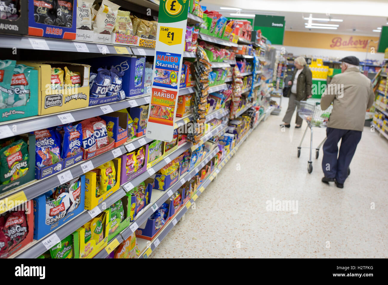 Sweets for sale - Interior of a Morrisons supermarket. Old man shopping Stock Photo