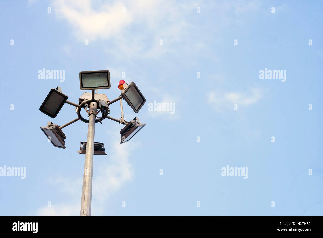 Less is more : Electric lights and a pole against blue sky Stock Photo ...