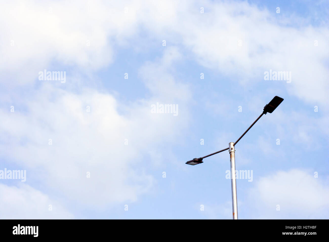 Less is more : Electric lights and a pole against blue sky Stock Photo ...