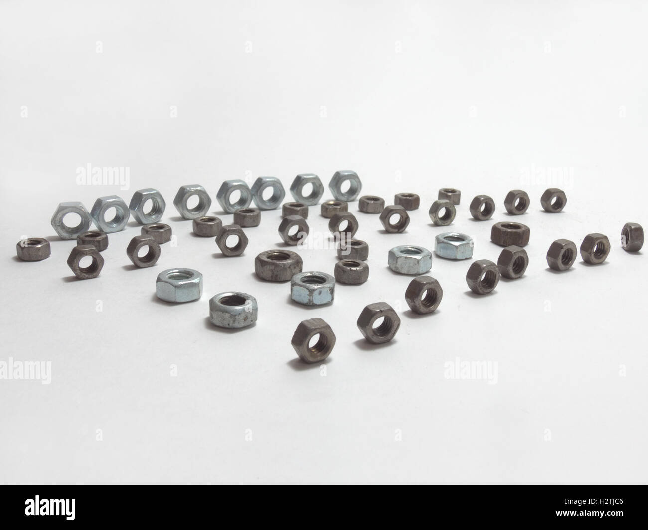 hex nuts of different sizes, beautifully positioned, in lines. The