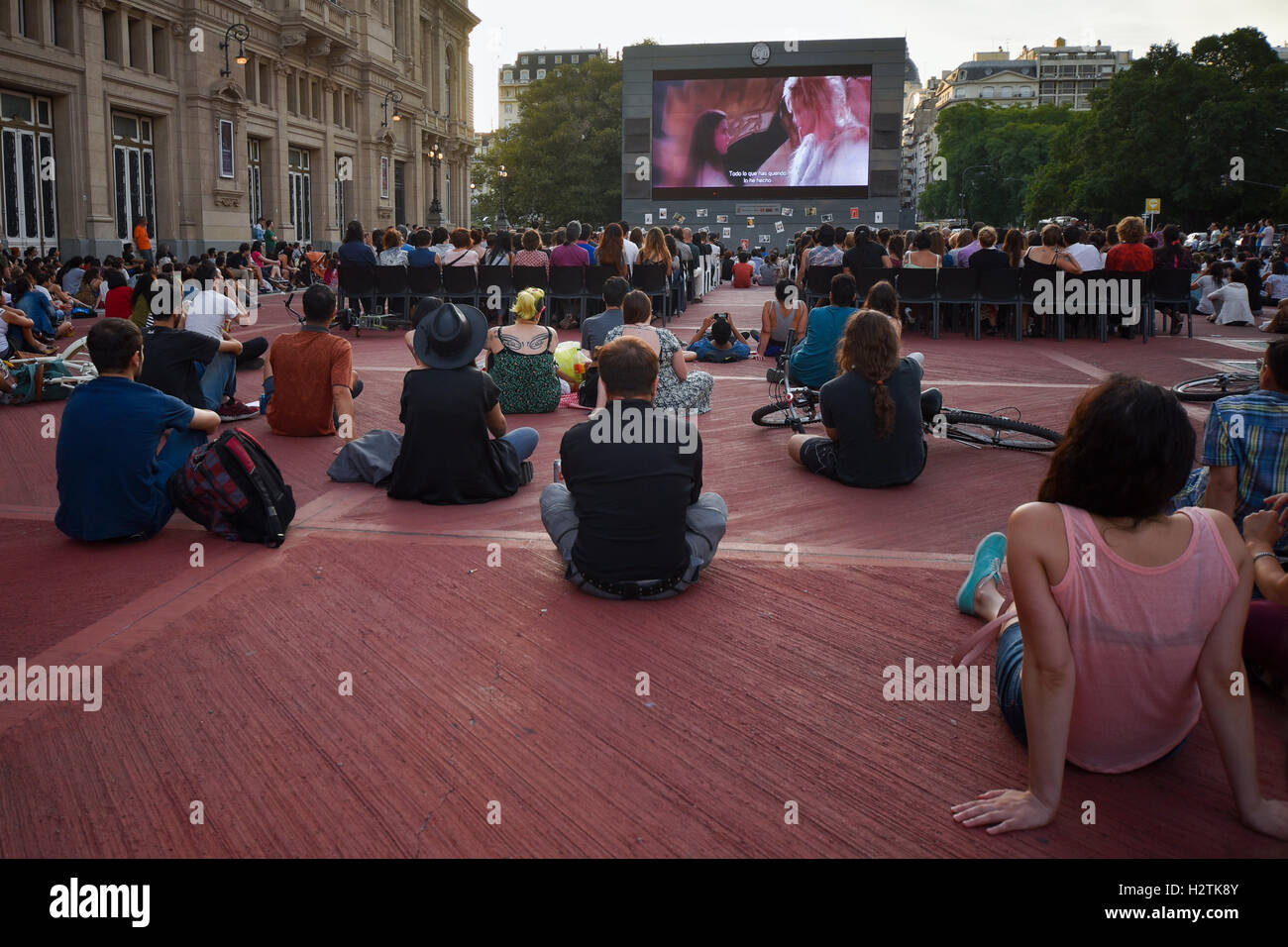 Buenos Aires, Argentina. 13 Jan, 2016. People gather in front of a giant screen during a projection of David Bowie's videos. Stock Photo