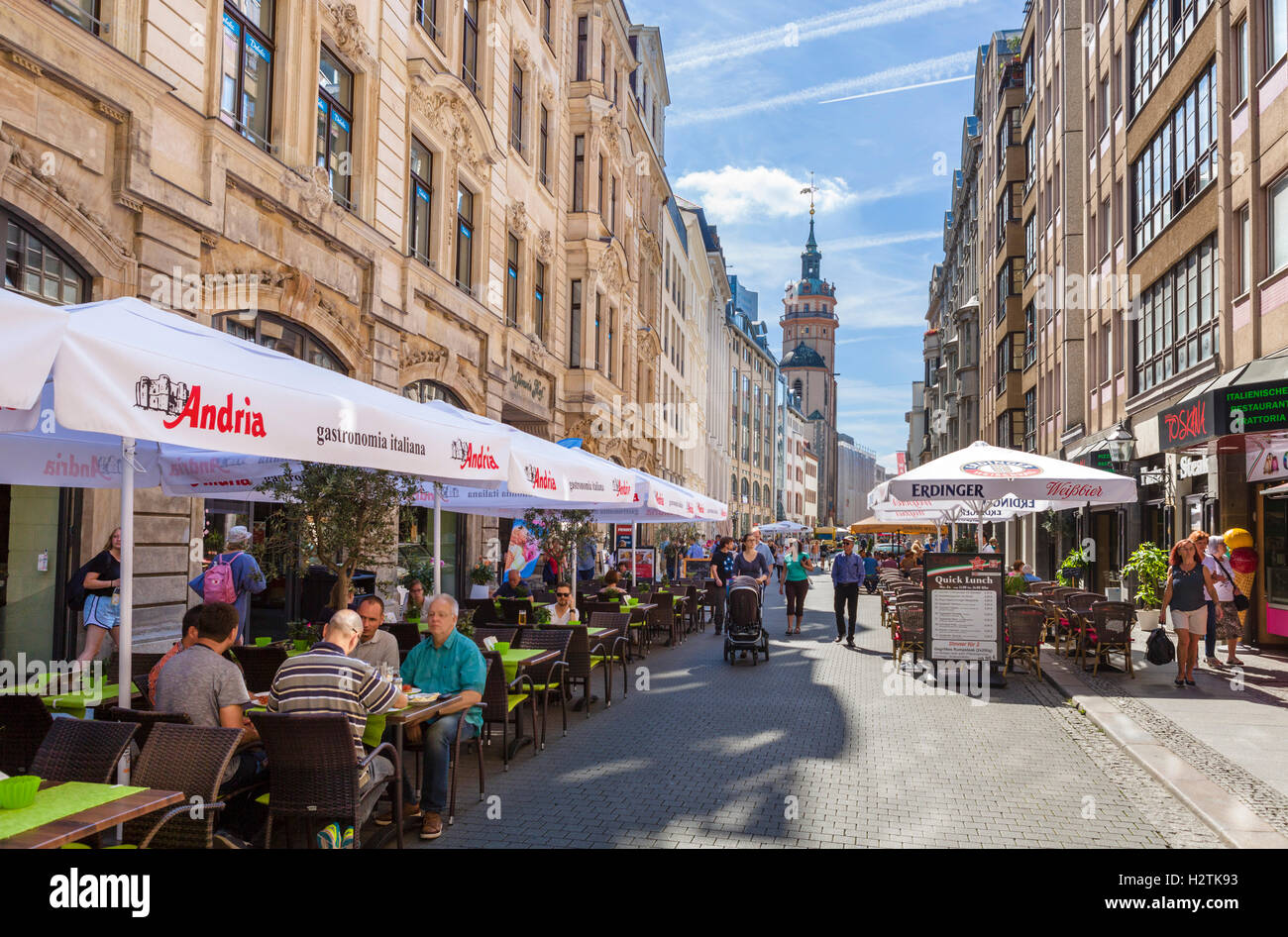 Leipzig, Germany. Pavement cafes on Nikolaistraße in the city centre, looking towards Nikolaikirche (St Nicholas Church), Leipzig, Saxony, Germany Stock Photo