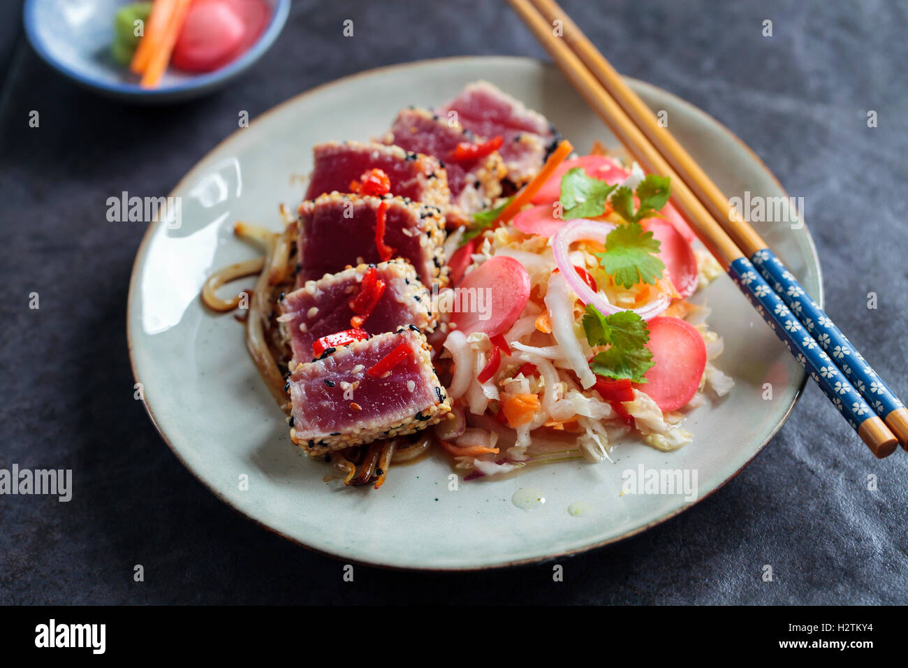 Sesame seeds crusted seared tuna with spicy asian salad and pickled