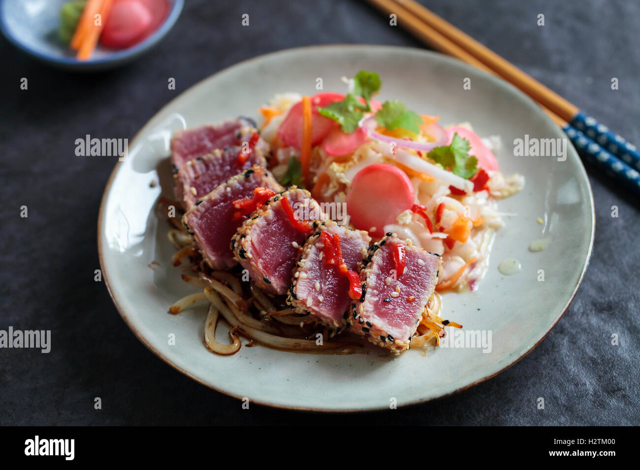 Sesame seeds crusted seared tuna with spicy asian salad and pickled