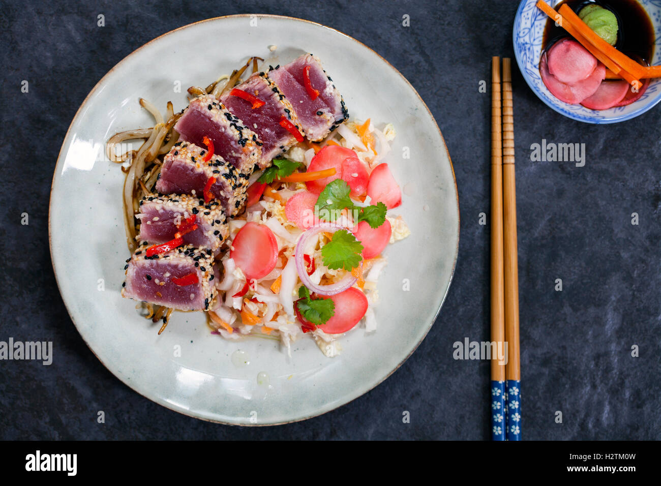 Sesame seeds crusted seared tuna with spicy asian salad and pickled