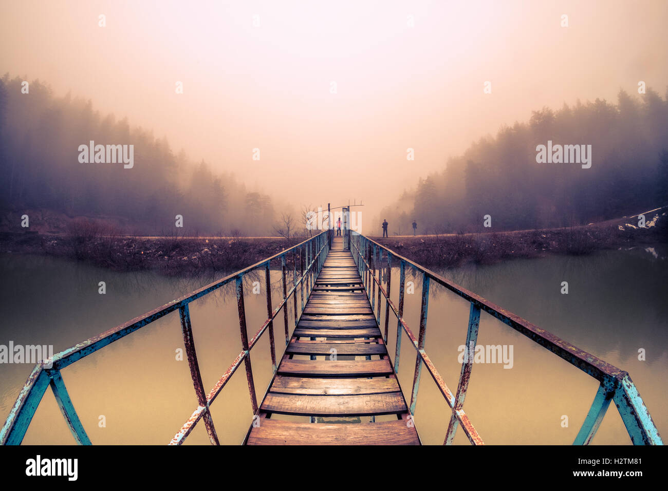 A perspective view of he bridge over the lake in a fogy morning Stock ...