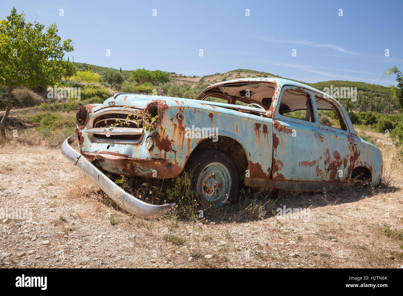 Zakynthos, Greece - August 20, 2016: Old abandoned rusted retro car stands in summer garden Stock Photo