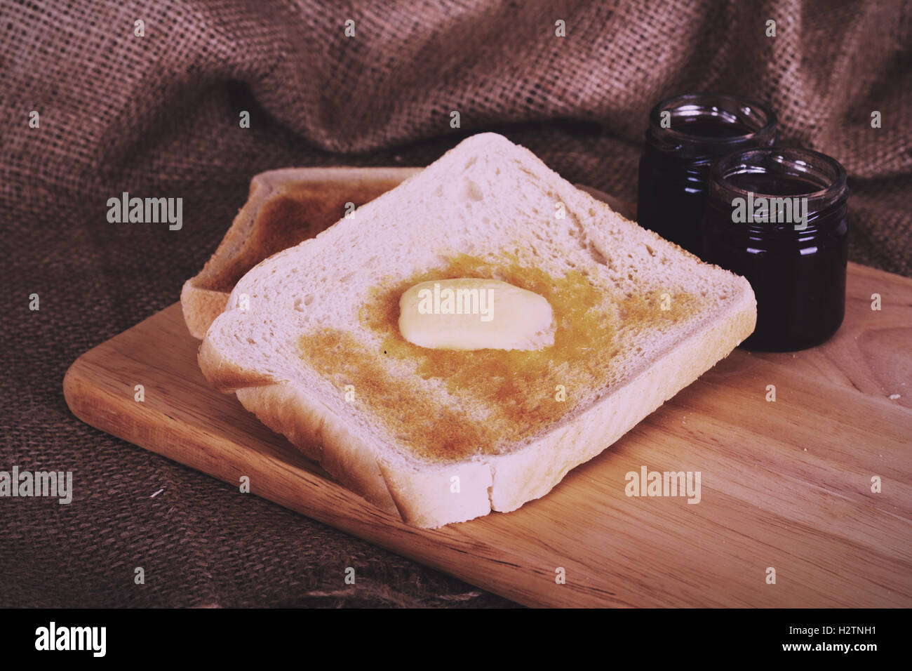 Slices of warm toast against a rustic wooden background Vintage Retro