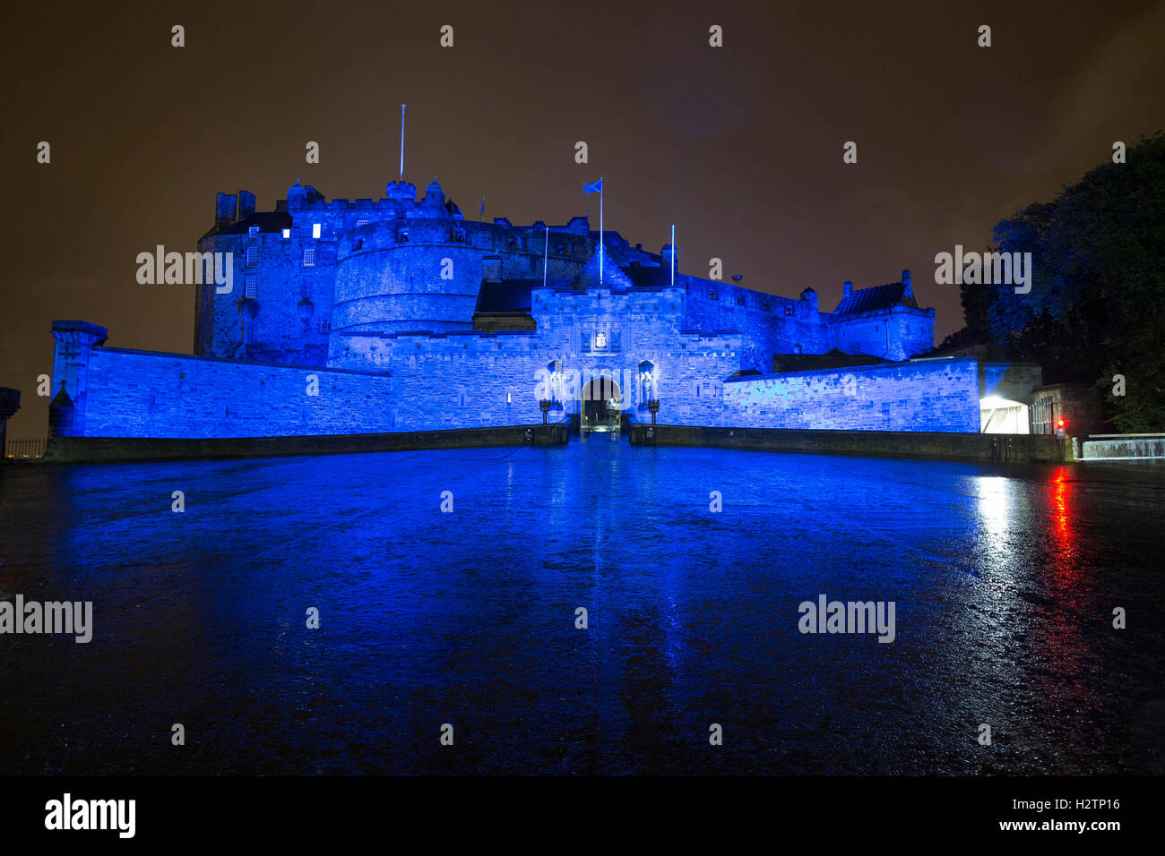 Edinburgh Castle at night bathed in Saltire Blue light Stock Photo