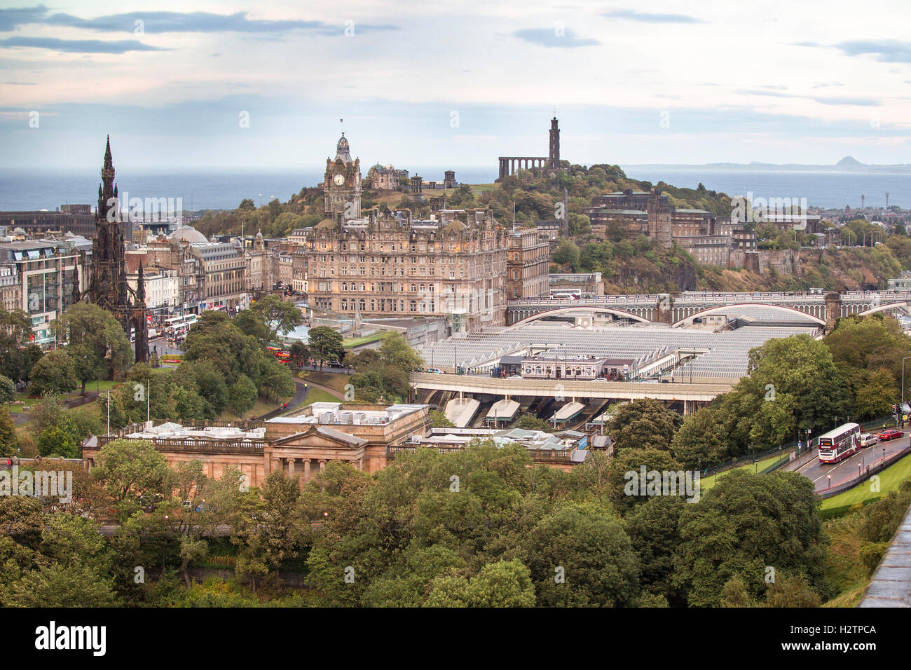 View of Edinburgh at twilight showing Princes Street, Waverly Station and Calton Hill Stock Photo